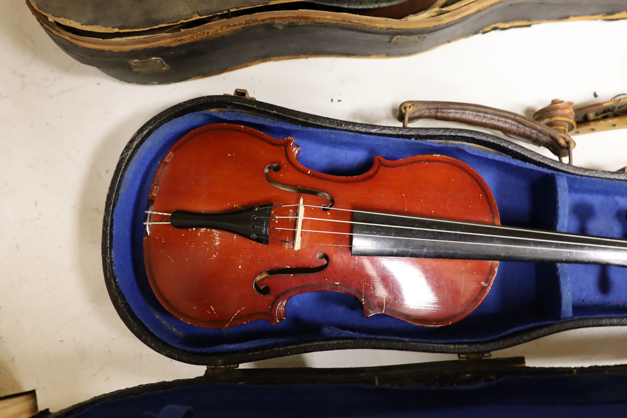 A German quarter size violin, a German violin a.f. and a modern violin